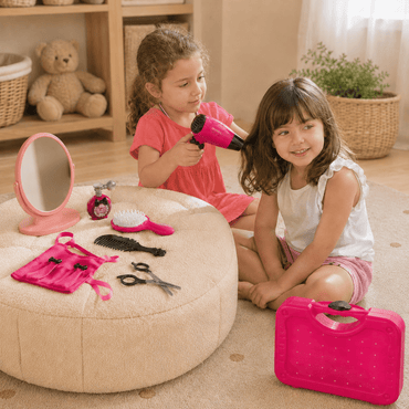 Two young girls playing with toy hairbrushes and a hair dryer on a beige ottoman.
