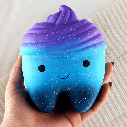 Galaxy Tooth Squishy Cradled on Knit Background
