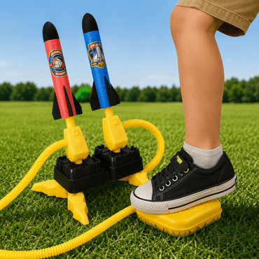 Child's feet on a toy rocket launcher with colorful rockets on grass, the ultimate birthday gift for kids in summer