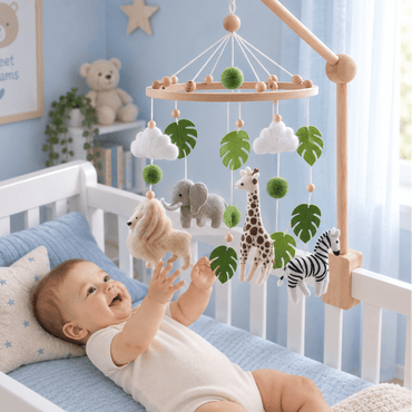 Baby reaching up to touch a wooden safari mobile hanging above the crib - nursery decor ideas