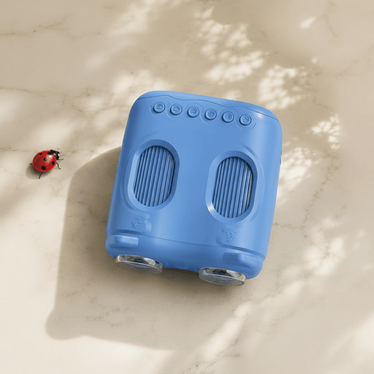 Blue toy microscope on a surface with baby toys and clothing in the background