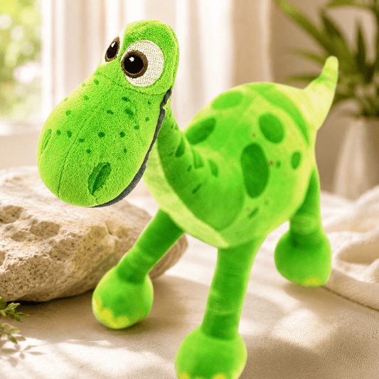 Close-up of a green dinosaur plush toy showing its soft spotted fabric and face