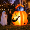 Kids in ghost and black cat costumes beside the glowing kitty cat pumpkin Halloween inflatable at night on a lawn with string lights