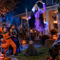 Trick-or-treating kids reacting to an 8 ft animated flying witch Halloween decoration swooping over a night-time porch