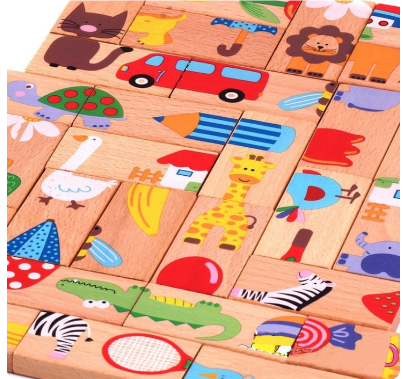 Wooden blocks with colorful animal and object illustrations on a wooden surface.