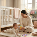 Woman playing with a baby on a rug in a nursery
