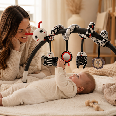 Woman and baby playing with a baby mobile in a nursery