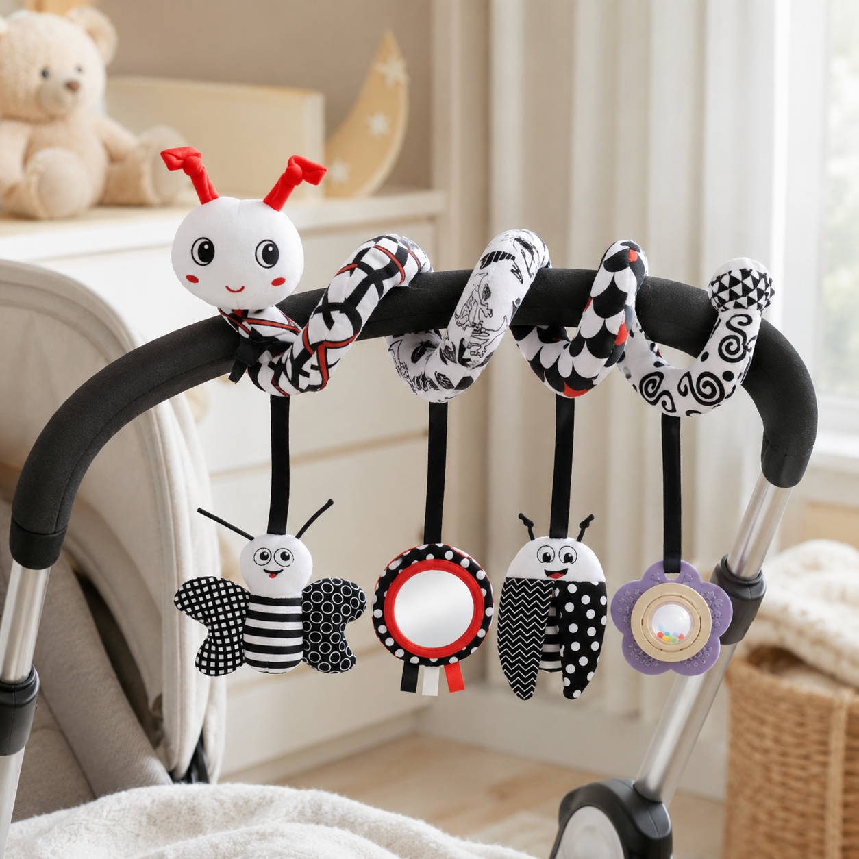 Baby stroller toy with various shapes and patterns hanging from a stroller handle.