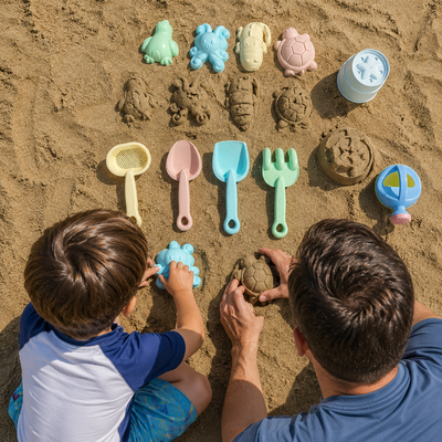 A top-down view of a father and son building sand castles in the sand, surrounded by a colorful set of plastic sand toys including molds, shovels, and buckets.