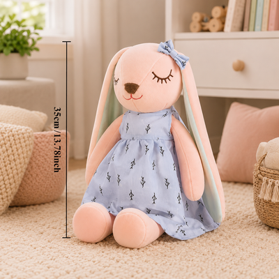 Plush toy rabbit in a blue dress with measurements on a soft surface