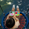 Toddler reading farm felt busy book outdoors — portable sensory activity for babies
