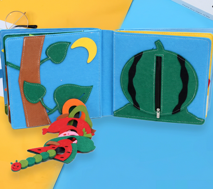 Children's felt book with colorful illustrations of a caterpillar, leaves, and a watermelon.