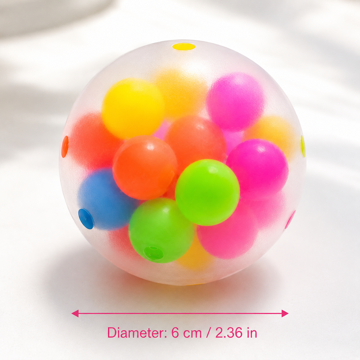 Transparent squishy ball with colorful beads inside, showing measurement details on a white background