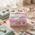 Pink toy storage box with baby toys on a soft surface