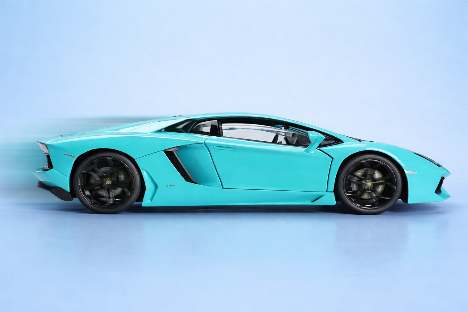 Turquoise Lamborghini sports car on a light blue background
