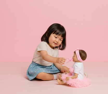 Child playing with a doll on a pink background