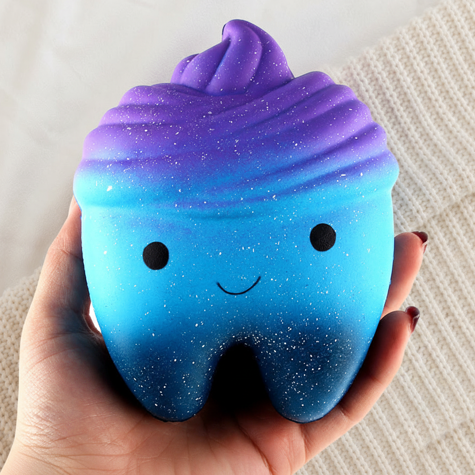 Galaxy Tooth Squishy Cradled on Knit Background