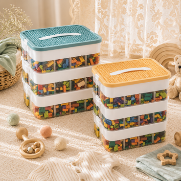 Two stackable plastic toy storage bins filled with colorful building blocks