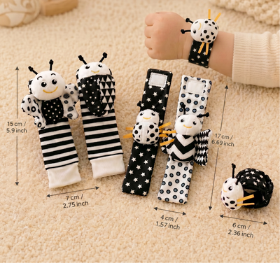 Set of black and white bee-themed baby socks  and ankle and wrist spiral toy additions