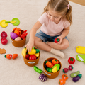 Toddler girl sorting fruits and vegetables into labeled baskets, teaching food categorization, a birthday gift for a 2 year old girl