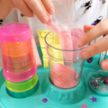 Close-up of pink slime powder being poured into the DIY Crystal Slime Mixer Kit shaker cup