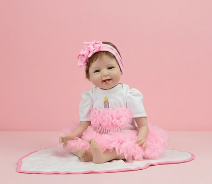 Baby doll in a pink outfit with a headband and tutu on a pink background
