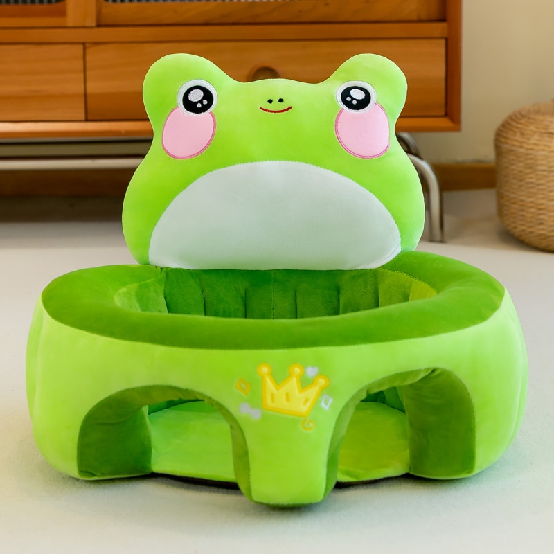 Green frog-shaped stool with a cartoon face on a light-colored floor.