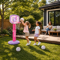 Pink Grow With Me basketball hoop set with two girls playing in a backyard while a parent watches