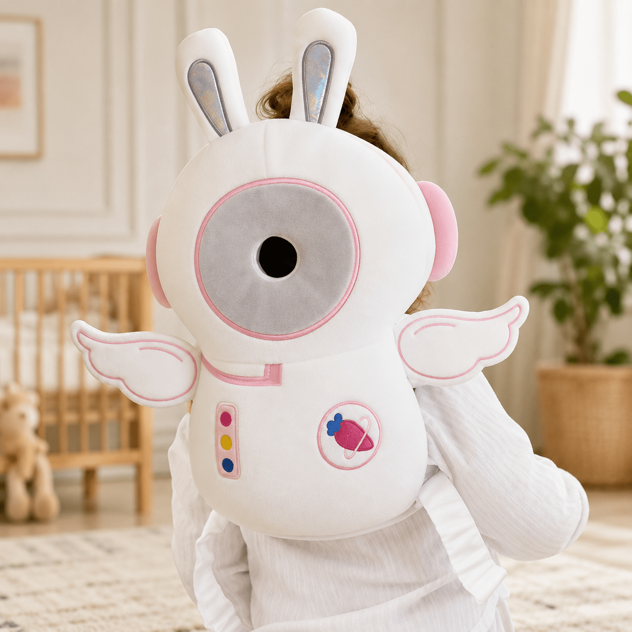 Toddler crawling on the floor wearing the astronaut anti-fall safety pillow