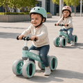Two toddlers riding balance bikes outdoors, developing coordination and balance